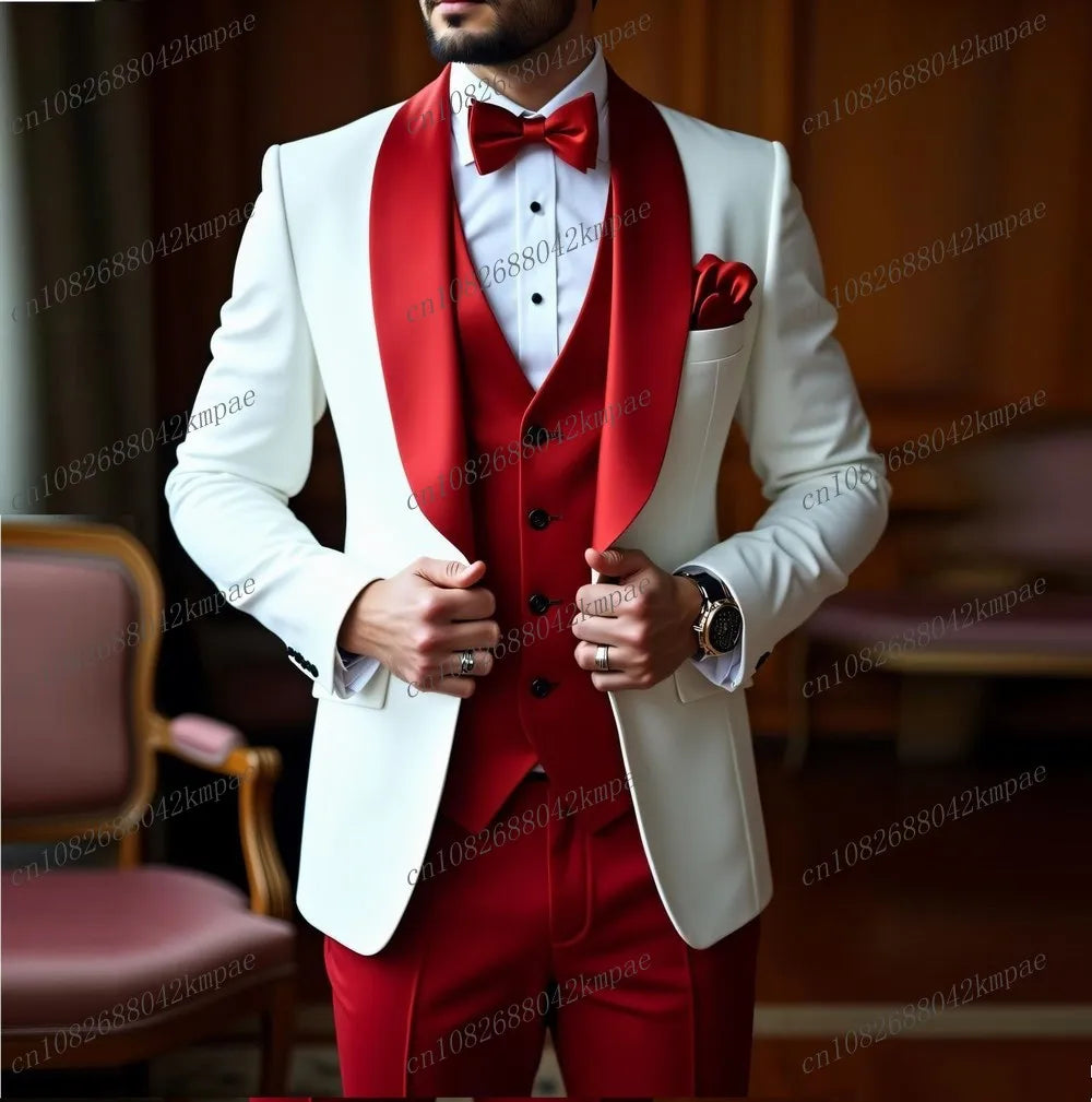 A man wears a white blazer with a red shawl lapel, red vest, and red bowtie for a formal event.