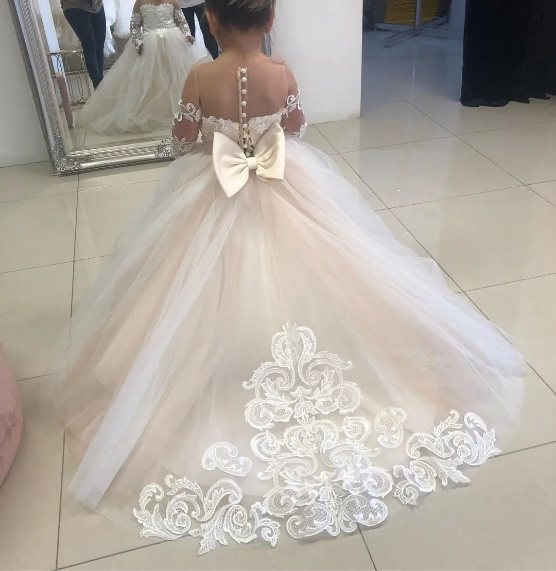 Baby girl lace flower girl dress by Showlu Fashion with long sleeves and tulle skirt for special occasions.
