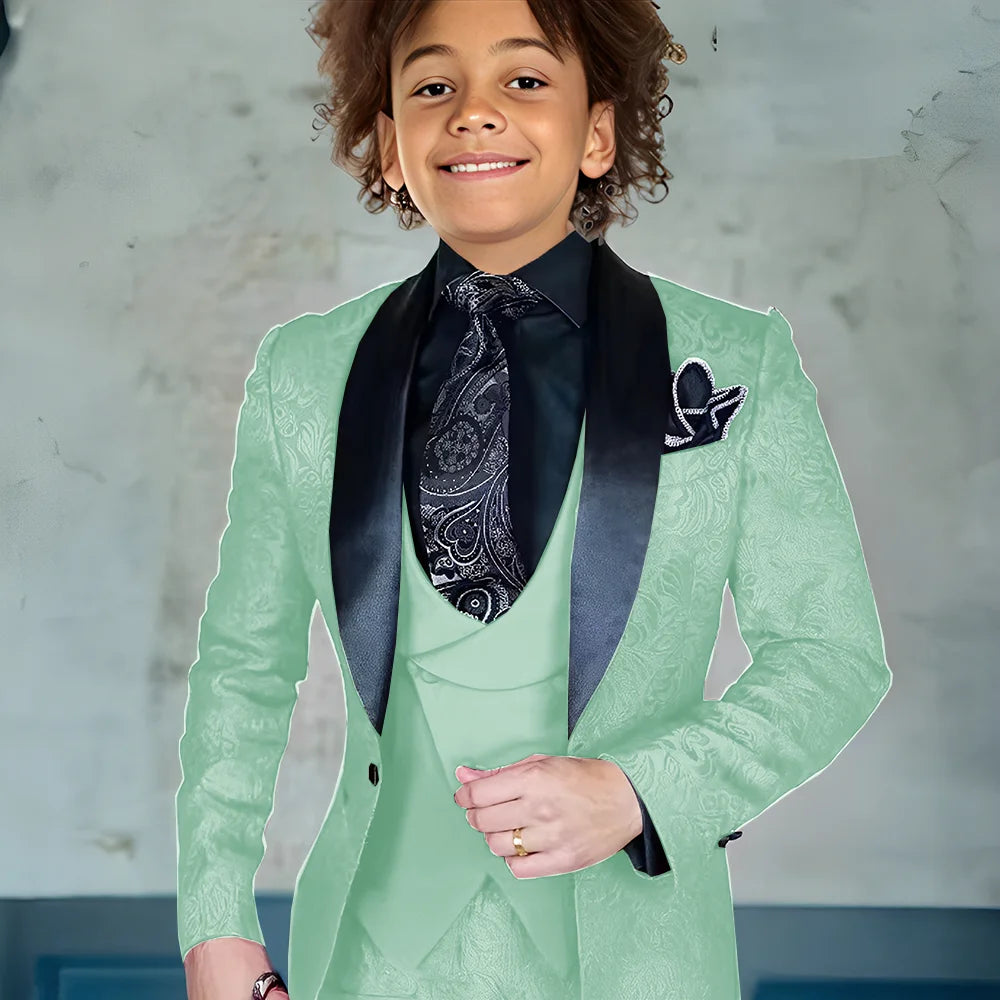 Burgundy three-piece boys suit with jacket, pants, and vest, featuring a slim fit style for formal occasions and weddings