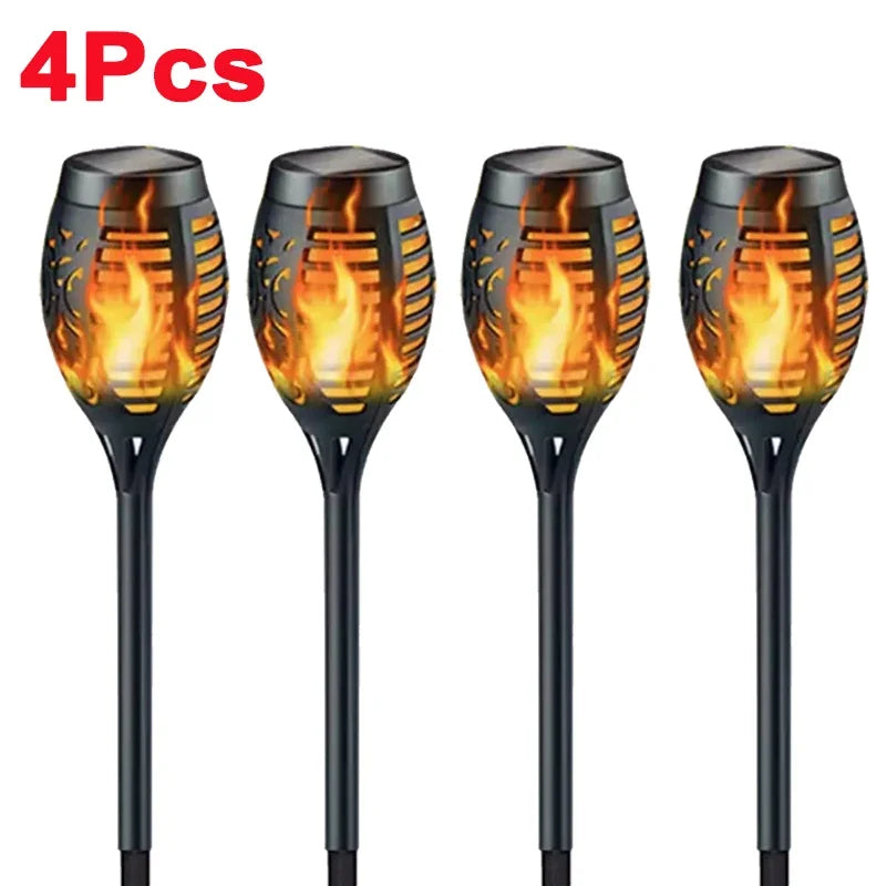Solar Dancing Flame LED Garden Lantern by Showlu Smart General with flickering flame effect in a garden setting