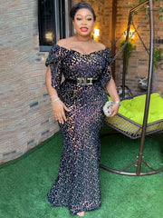 A woman wears a floor-length, off-the-shoulder black sequin mermaid dress with petal sleeves.