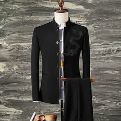 A black slim-fit suit featuring a stand collar blazer with dragon embroidery and matching trousers.