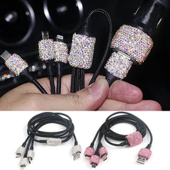 A hand holds a multi-cable car charger decorated with sparkling rhinestones, with two full sets shown below.