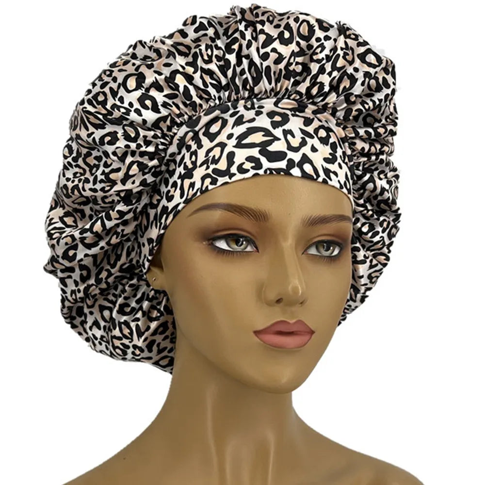 Leopard print women's sleep bonnet with wide elastic band, soft and curl-enhancing, suitable for dry and textured hair.
