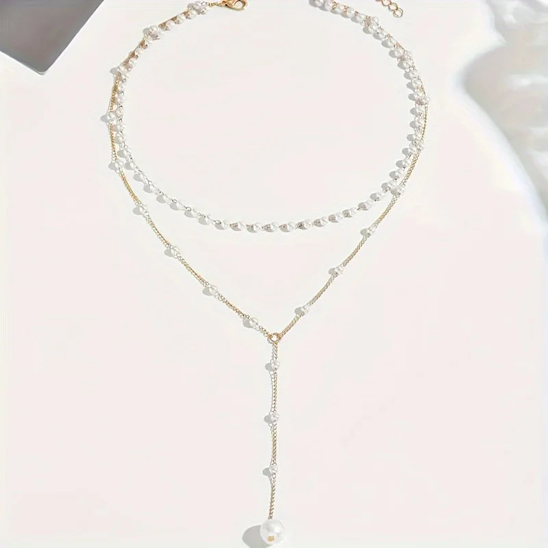 Elegant imitation pearl necklace with long tassel pendant, front chest chain design, stylish women's jewelry accessory.
