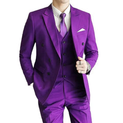 A man wears a vibrant purple three-piece double-breasted suit with a white shirt and purple tie.