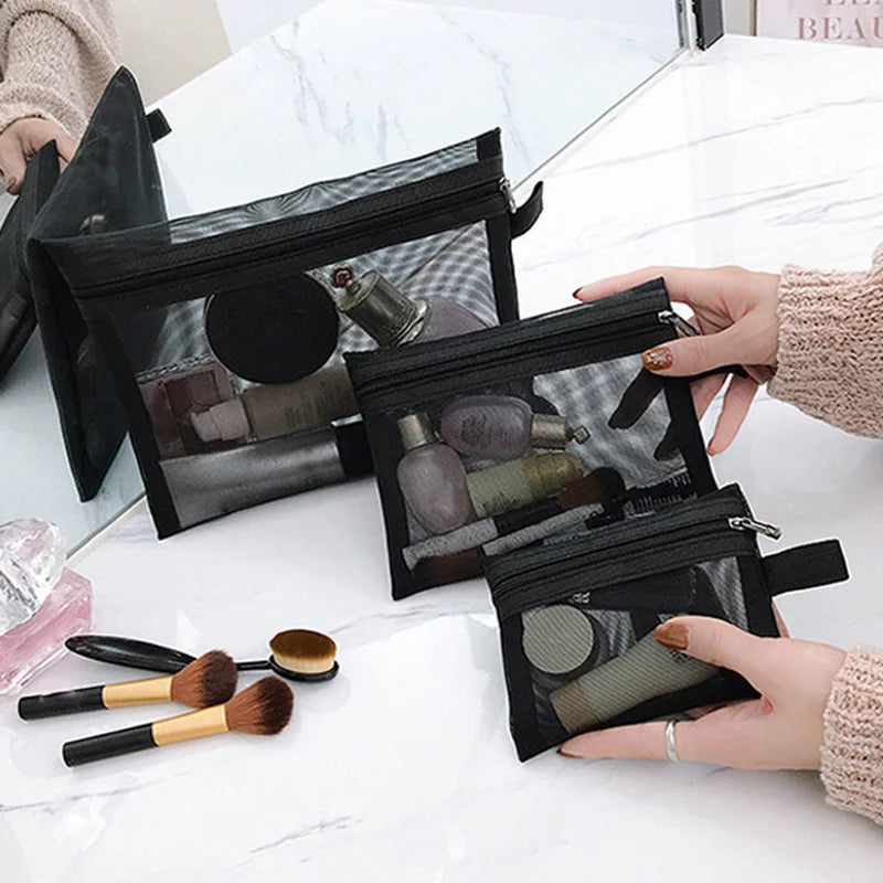 Black transparent mesh makeup bag for women, showing compact and large cosmetic storage with zipper closure and multiple compartments.