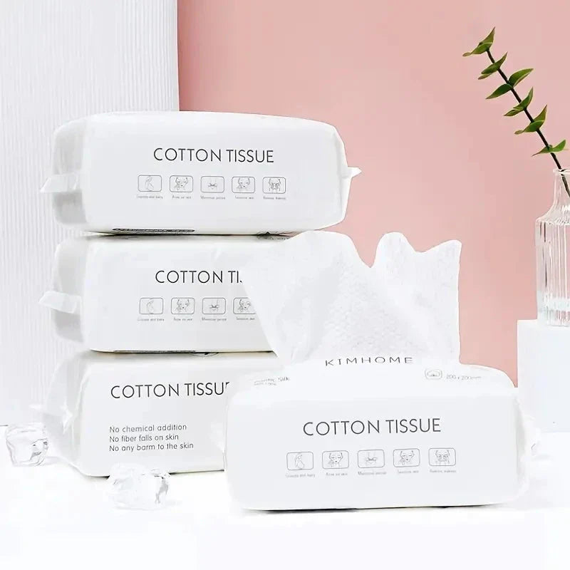 Set of 100 soft cotton disposable face towels from Showlu Fashion, lightweight dry cloths for skincare and cleansing.