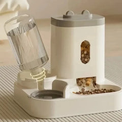 A white automatic pet feeder with a water dispenser and a food storage container.