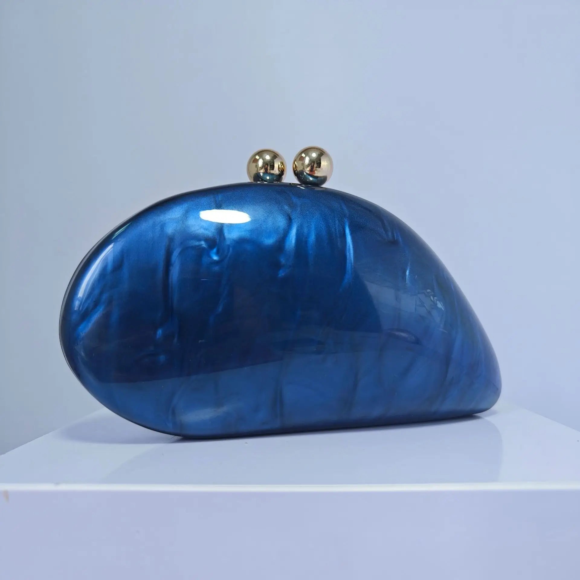 Blue acrylic shell-shaped clutch bag for women, designer evening party purse with pearl accents, ideal for stylish events.