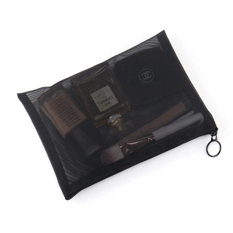 Large black portable outdoor makeup bag with transparent mesh sections for travel and home organization, showing multiple compartments.