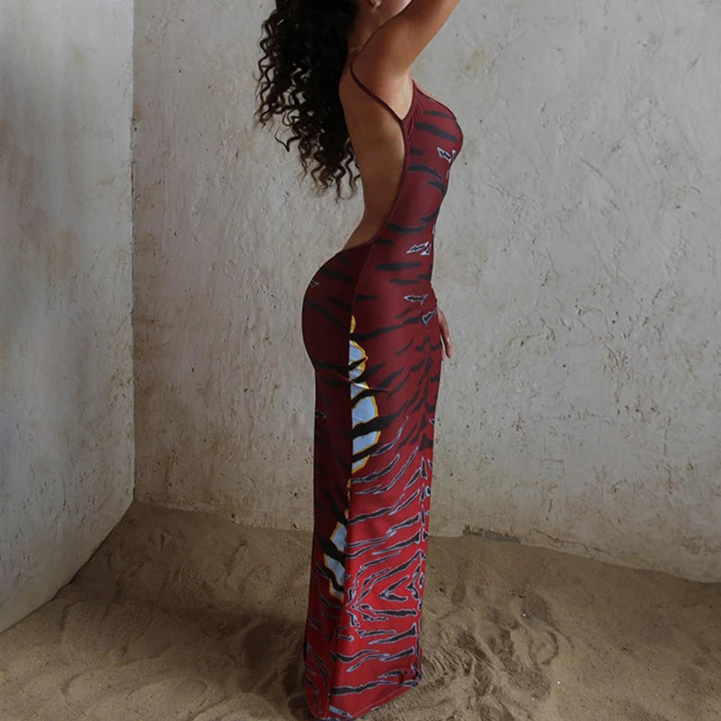 Backless printed sleeveless sling dress with low-cut neckline and fitted waist, perfect for summer parties and holidays.