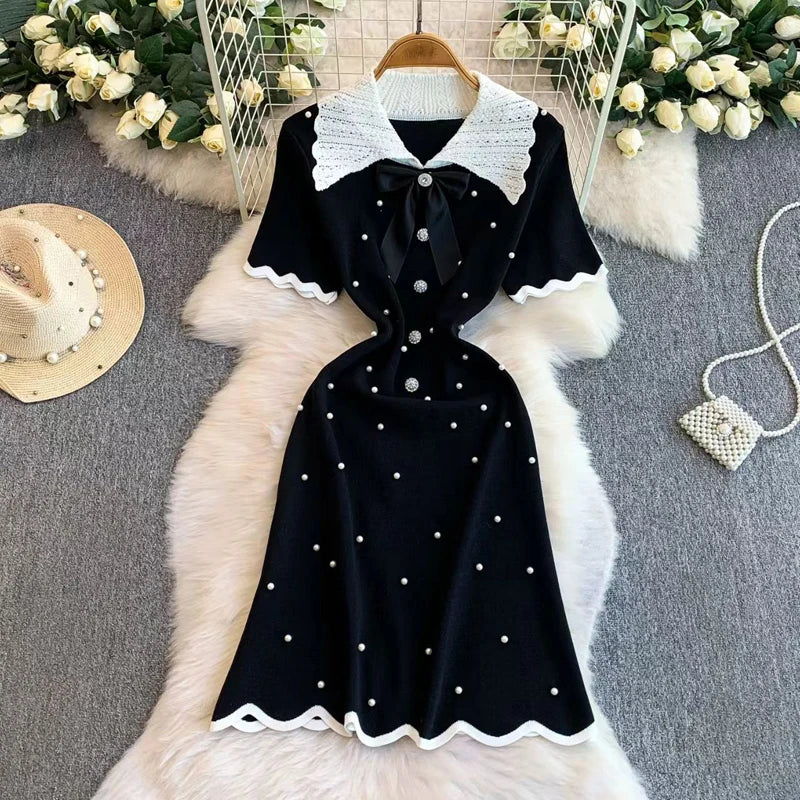 Elegant 2026 summer women's pearl dress by Showlu Smart General featuring a Hepburn style bow collar, short sleeves, and bodycon fit.