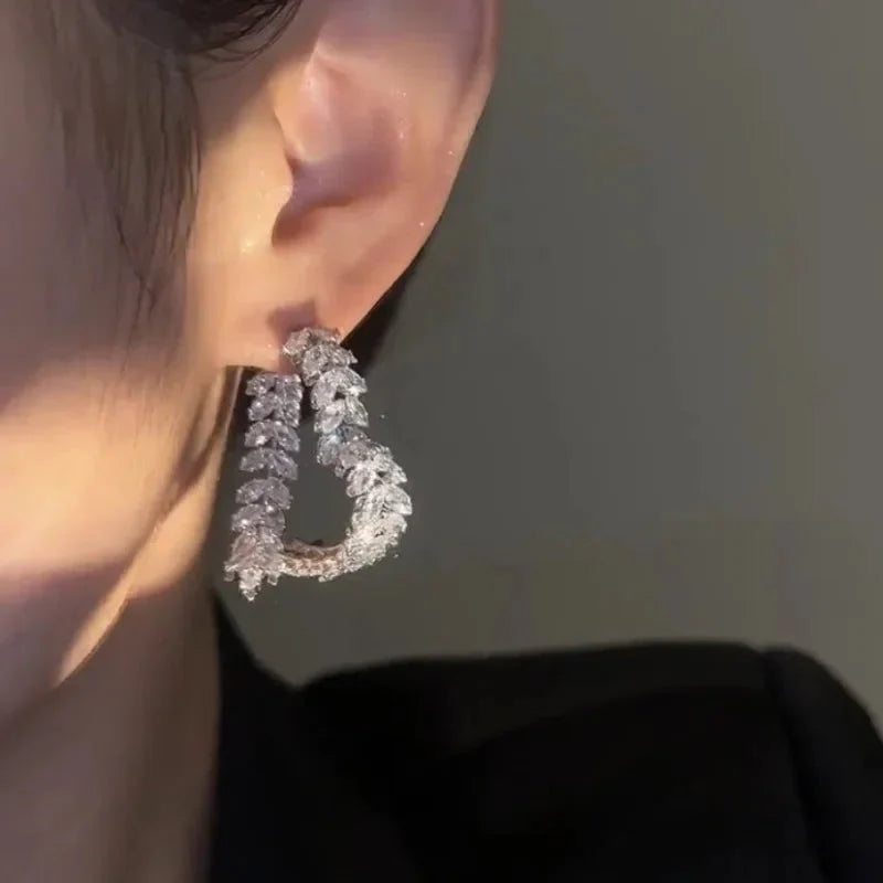 SHOWLU FASHION zircon leaf stud earrings with Korean style copper jewelry, featuring delicate leaf design and sparkling zircon accents.
