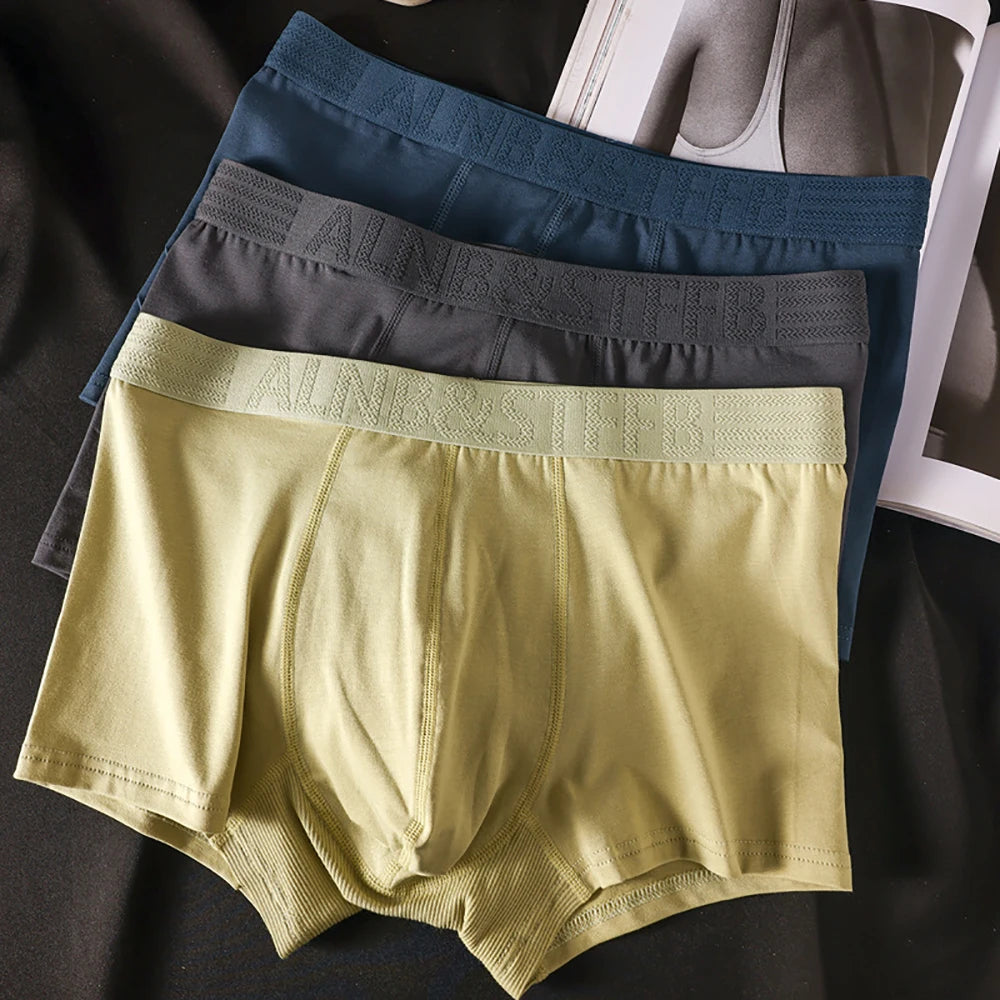 Three pairs of Showlu Fashion men's cotton antibacterial boxer briefs with double-layer breathable U pouch for comfort and hygiene.