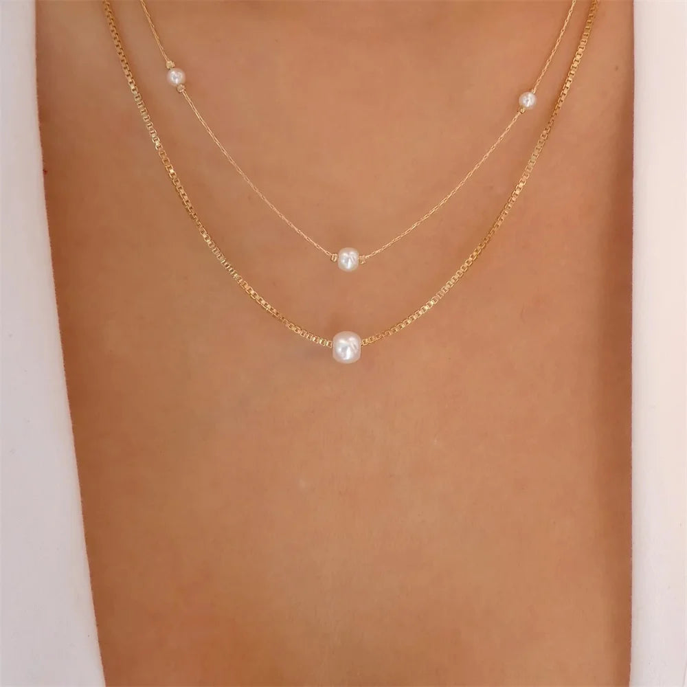 Vintage elegant round pearl pendant necklace with multi-layer gold chain for women and girls, trendy jewelry accessory.