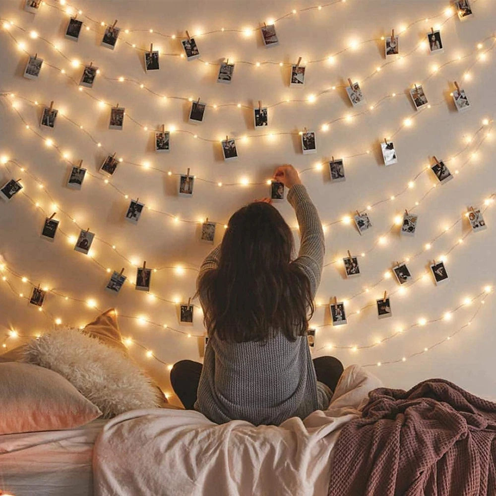 Showlu Smart LED photo clip string lights hanging with photos attached, ideal for decorative lighting and photo display.