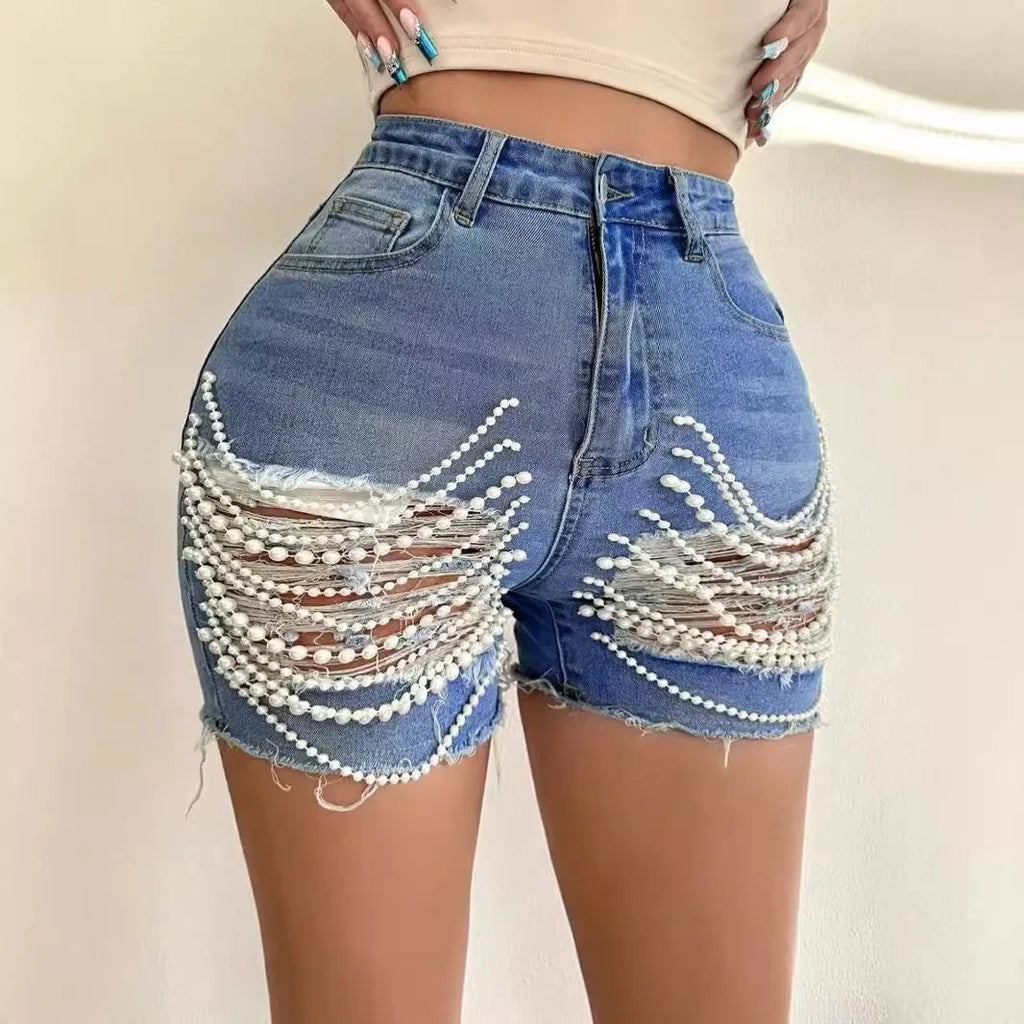 Kalenmos women's high waist ripped denim shorts with pearl chain detail, casual summer apparel, shown on a model.