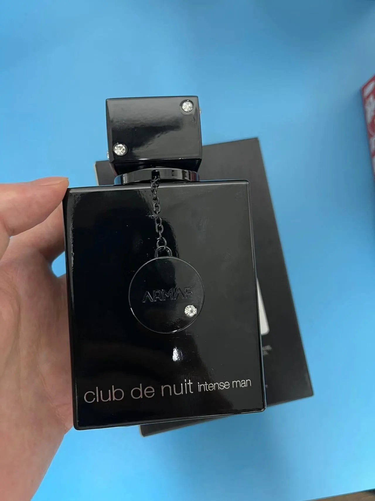 Armaf Club de Nuit Intense men's citrus aromatic woody EDT bottle with lime and woody accents, displayed on a neutral background.