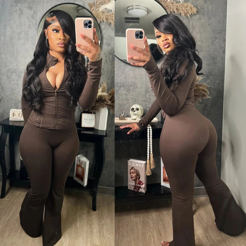 Women's two-piece tracksuit by SHOWLU FASHION with flared pants and zip-up top, casual athletic wear in black fabric.