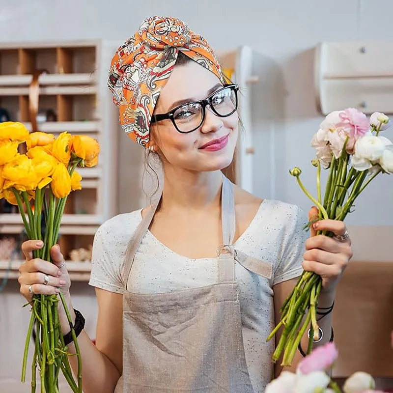 African print pleated turban with floral design, pre-tied beanie style, elastic head wrap, and front knot for women.