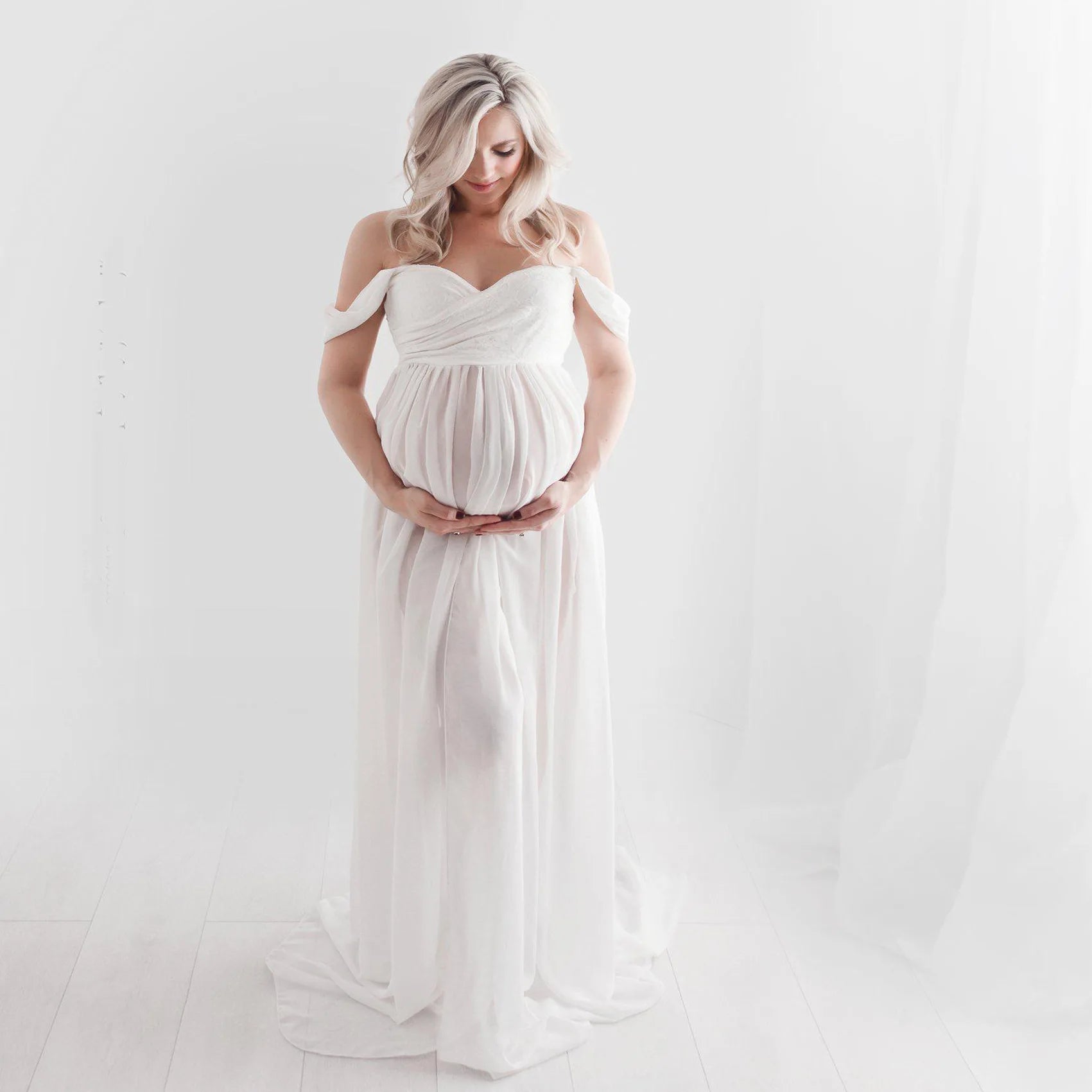 Deep V-neck tulle maternity dress by Showlu Fashion with lace hollow details, long sleeves, feather accents, perfect for photography.