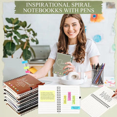 A woman sits at a desk with several spiral-bound inspirational journals and a pen holder.