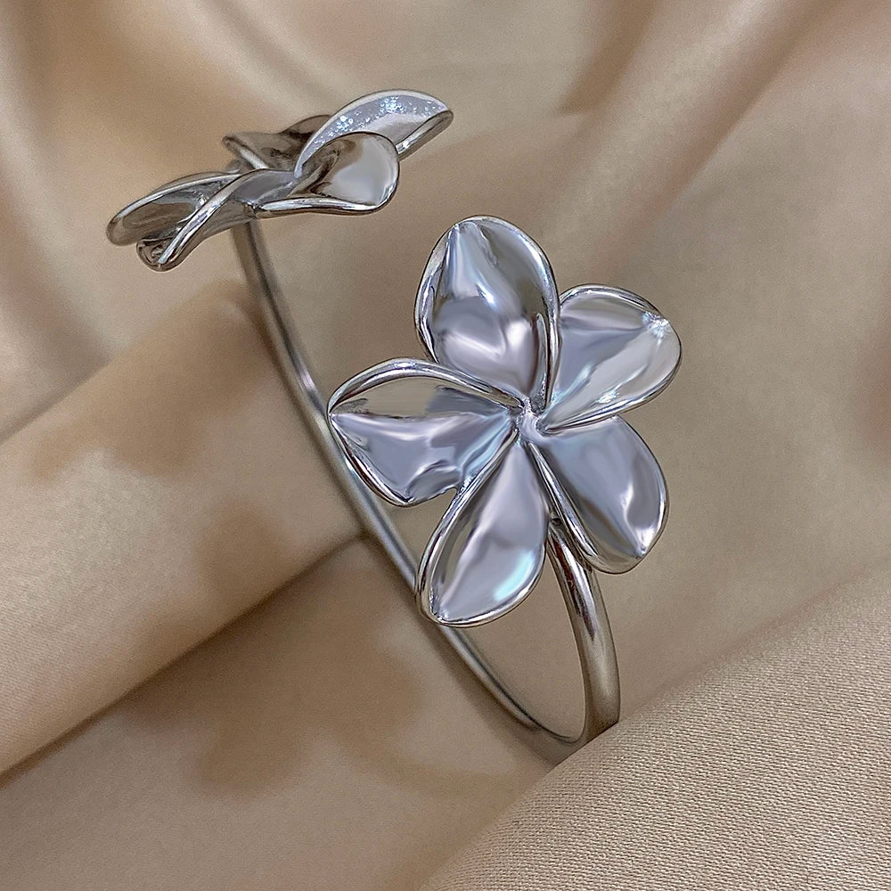 Greatera stainless steel double flower cuff bracelet for women, gold-tone floral bangle with waterproof jewelry design.