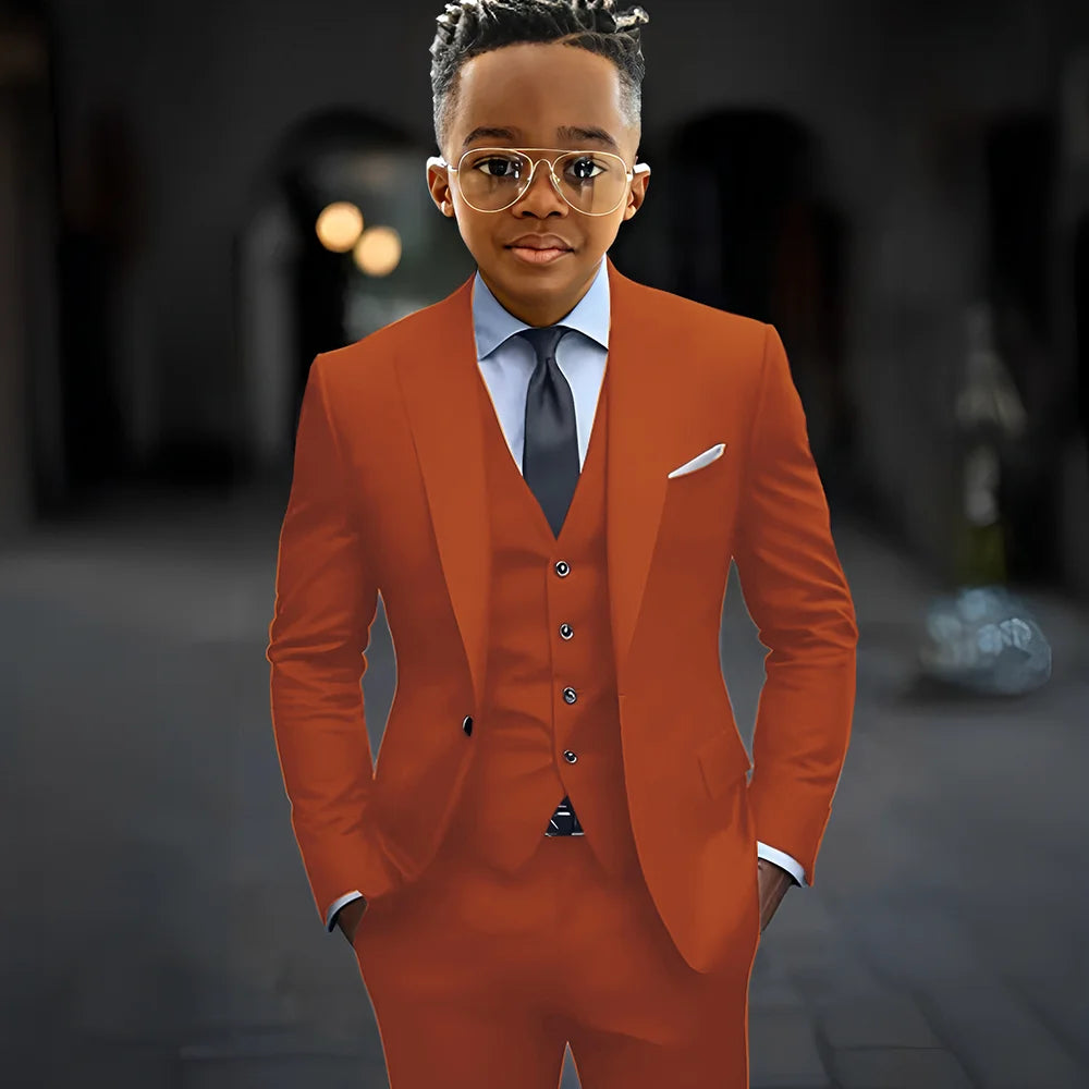 Dark grey boy's suit by Showlu Fashion with slim fit, single-breasted jacket, pants, and vest, featuring peak lapel for elegant style.