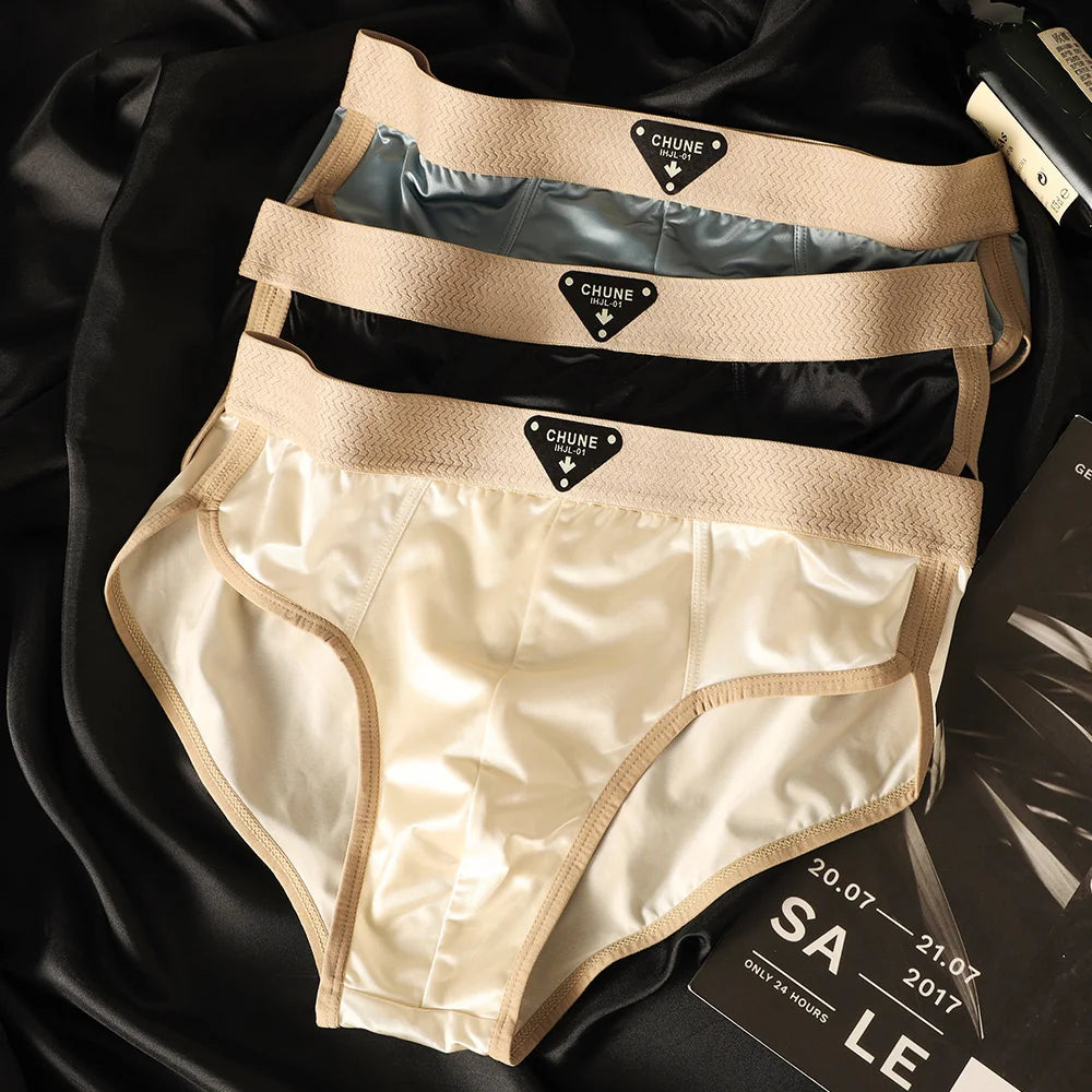 Three pairs of men's satin-like breathable briefs with mesh crotch, soft elastic fabric, and ice silk material from Showlu Fashion.