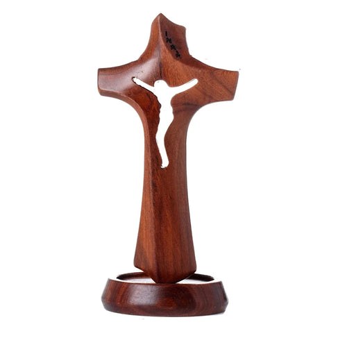 Wooden hollow cross sculpture with natural finish, standing on a base, vintage religious crucifix ornament for desktop display