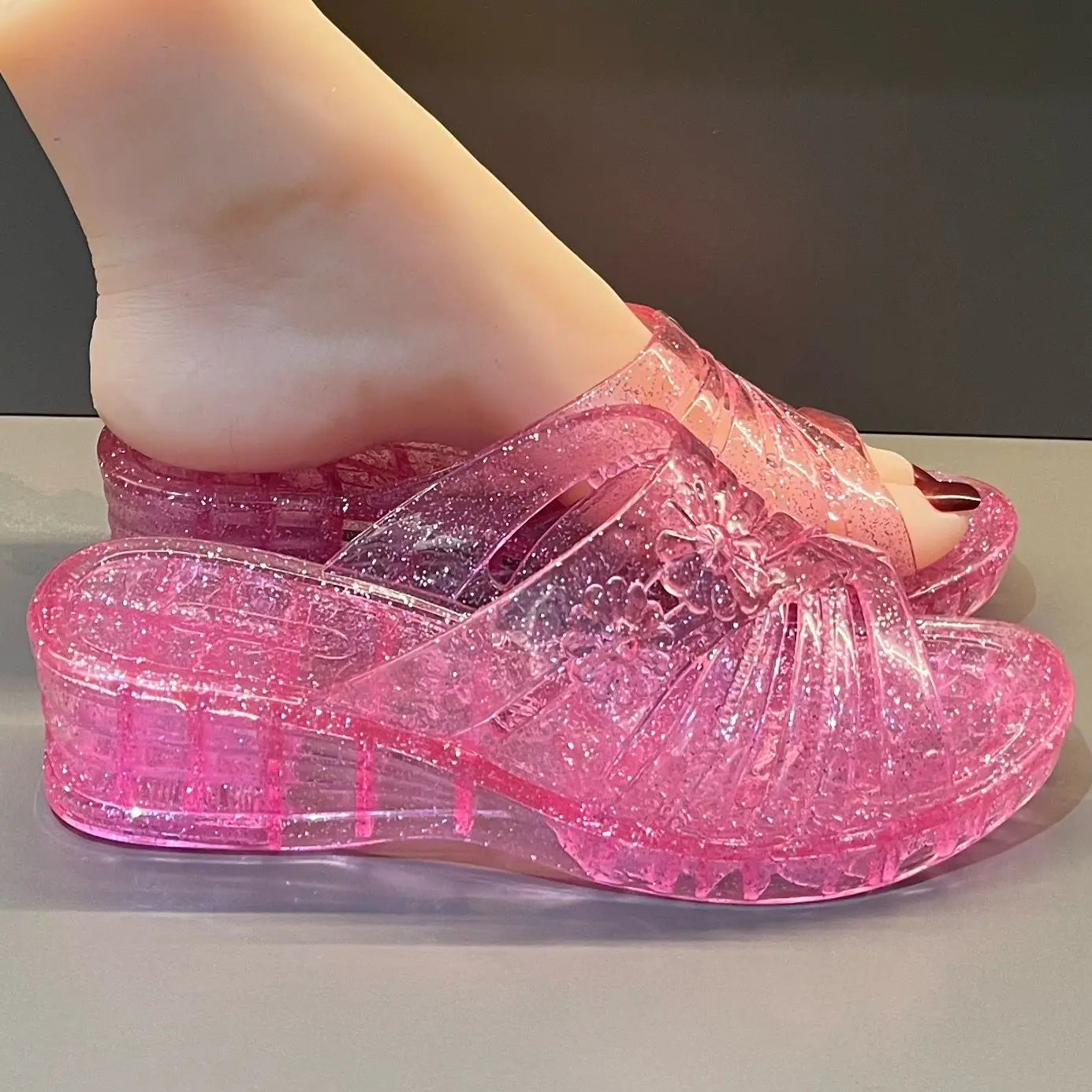 Lorilury Women's transparent jelly slippers with glitter wedge heels, stylish mule design, clear material, and open-toe style.