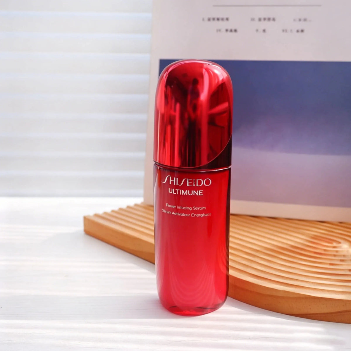 Shiseido Ultimune Power Infusing Concentrate IV face serum bottle with sleek packaging and applicator in close-up shot.