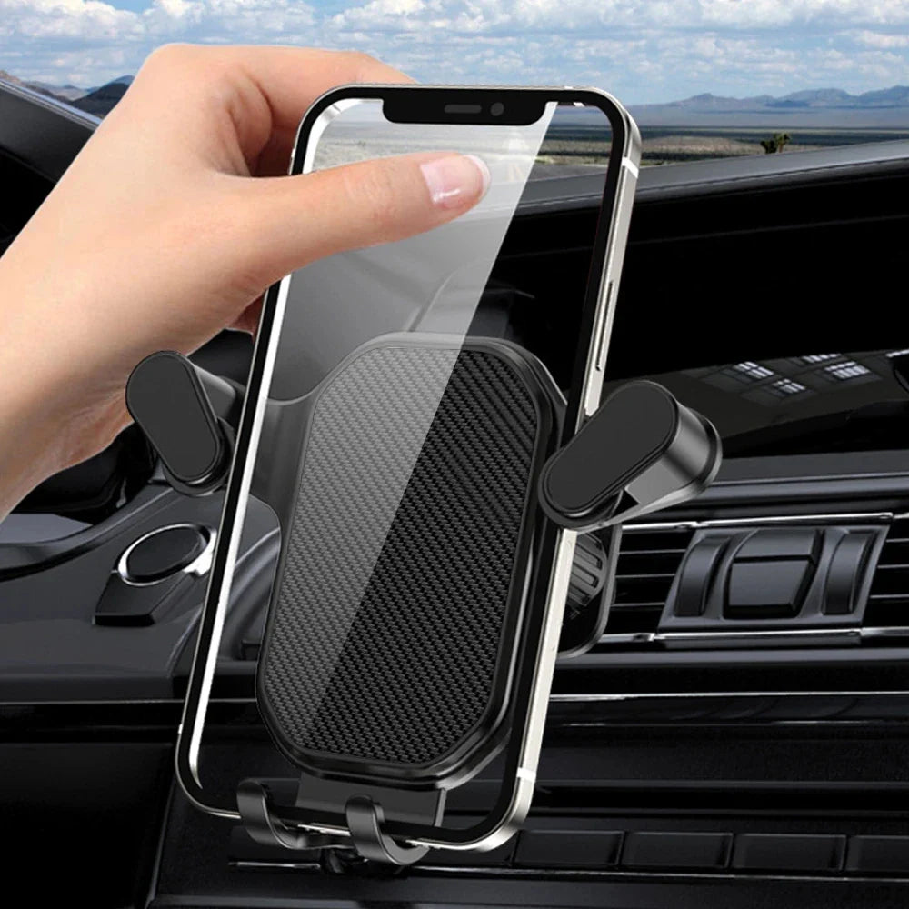 Gravity car phone holder by SHOWLU FASHION STORE with 360° air vent hook mount, securely holds smartphones in vehicles.