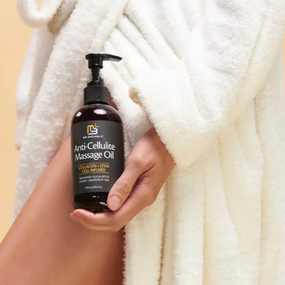 M3 Naturals anti-cellulite massage oil bottle with grape seed and eucalyptus for firming and skin improvement.