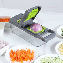 A multifunctional kitchen chopper with a grey frame and green blade insert slicing an onion.