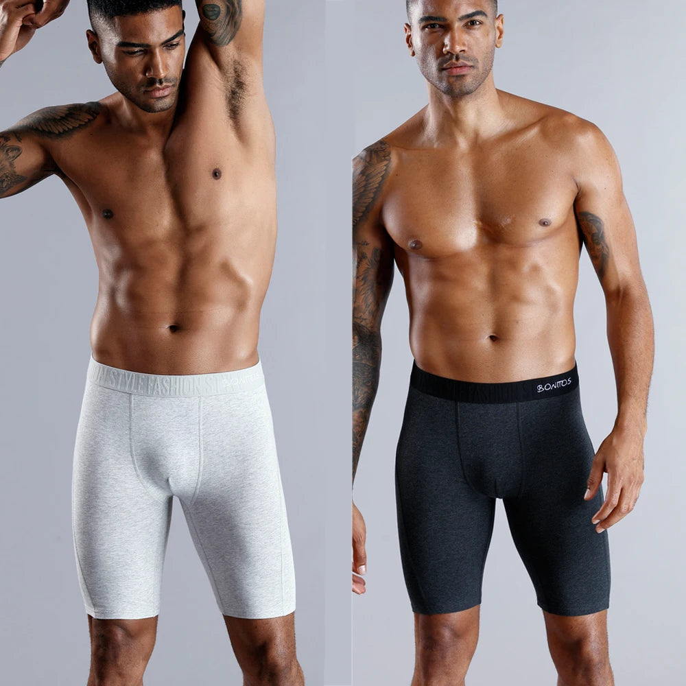Men's long leg boxer shorts in a 4-pack by SRBONITOS, soft cotton trunks in plus size, shown in black and navy colors.