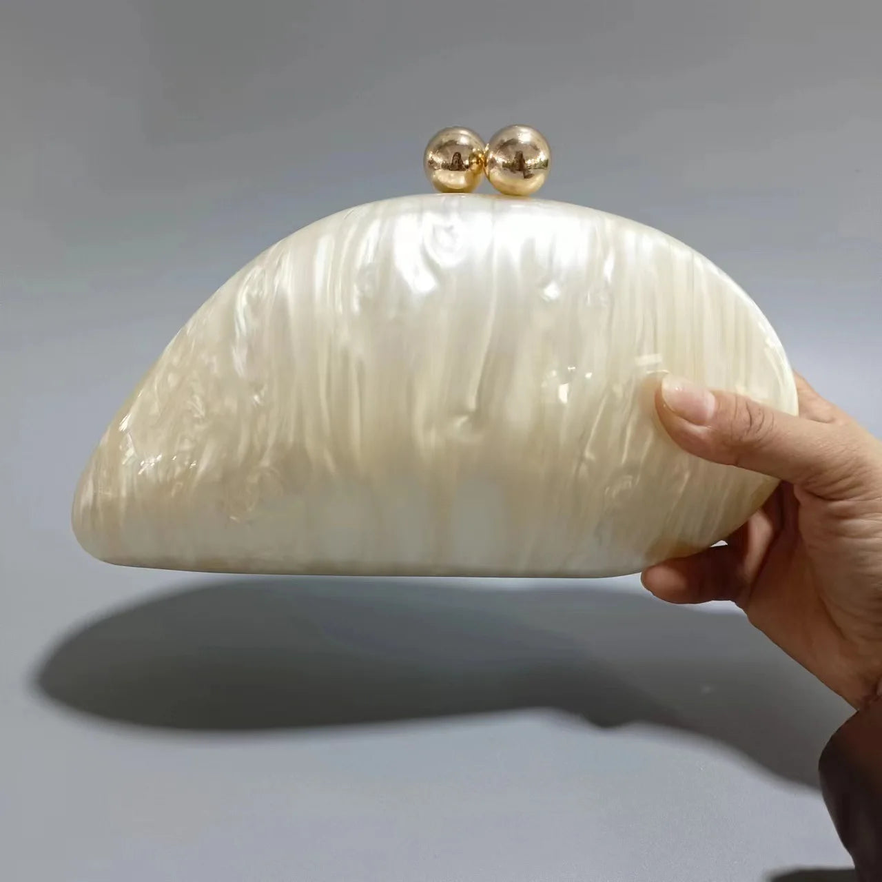 Blue acrylic shell-shaped clutch bag for women, designer evening purse with pearl details, perfect for parties and special occasions.