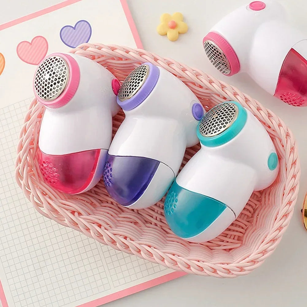 Showlu Smart General electric lint remover fabric shaver with a handheld design and a transparent lint collection compartment.