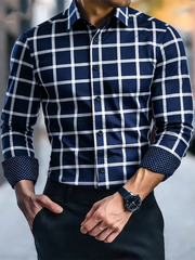 A men's navy blue long-sleeved button-down shirt with a white grid pattern and polka dot cuffs.