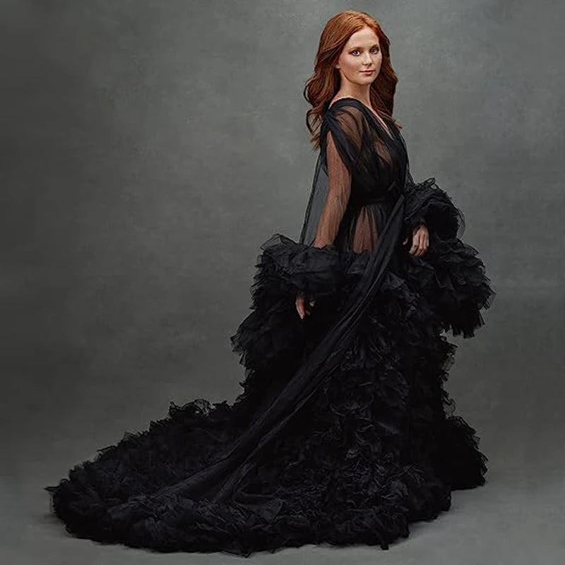 Deep V-neck tulle maternity dress with lace hollow details, long sleeves, feather accents, and trailing design, perfect for photo shoots.