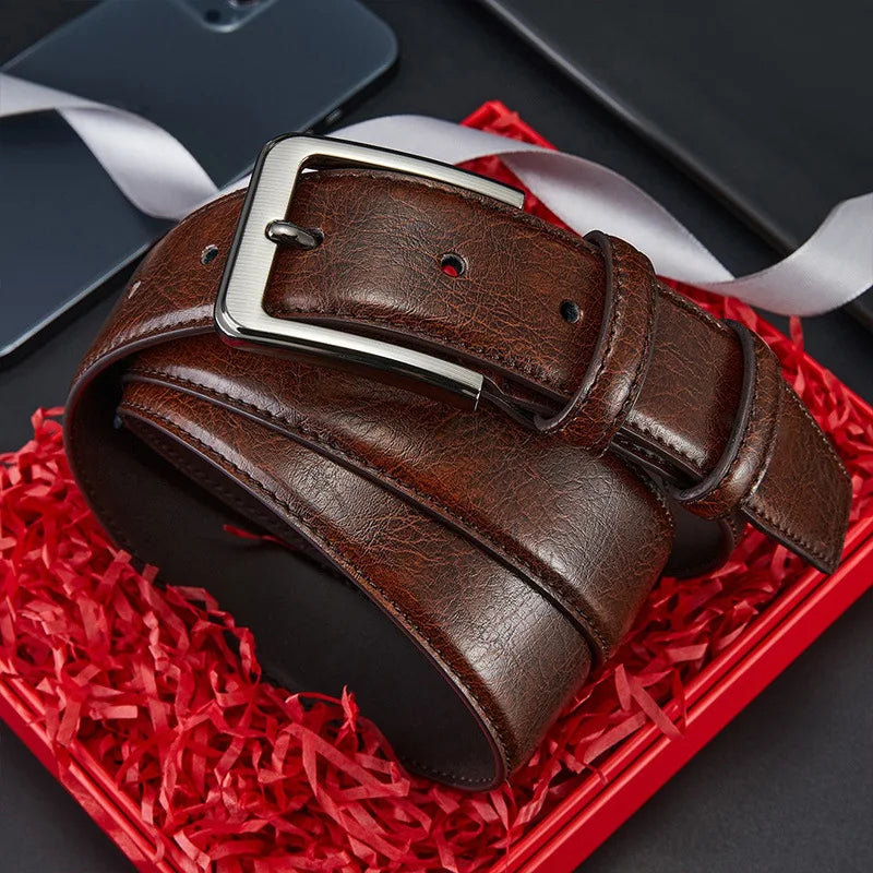 Men's genuine split leather belt with alloy needle buckle by Showlu Fashion, showing close-up of black leather strap and buckle details.