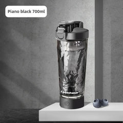 A piano black 700ml electric protein shaker bottle with a USB rechargeable base.