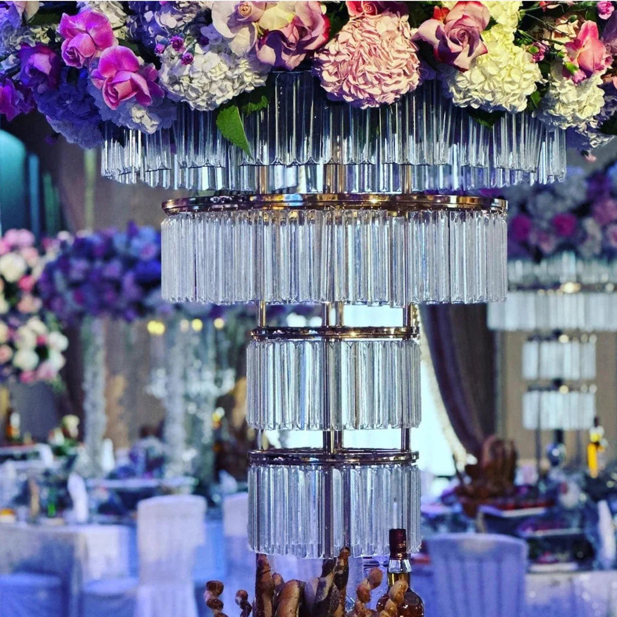 Tall gold crystal wedding centerpiece with a four-layer metal stand, featuring elegant crystal accents for wedding decor.