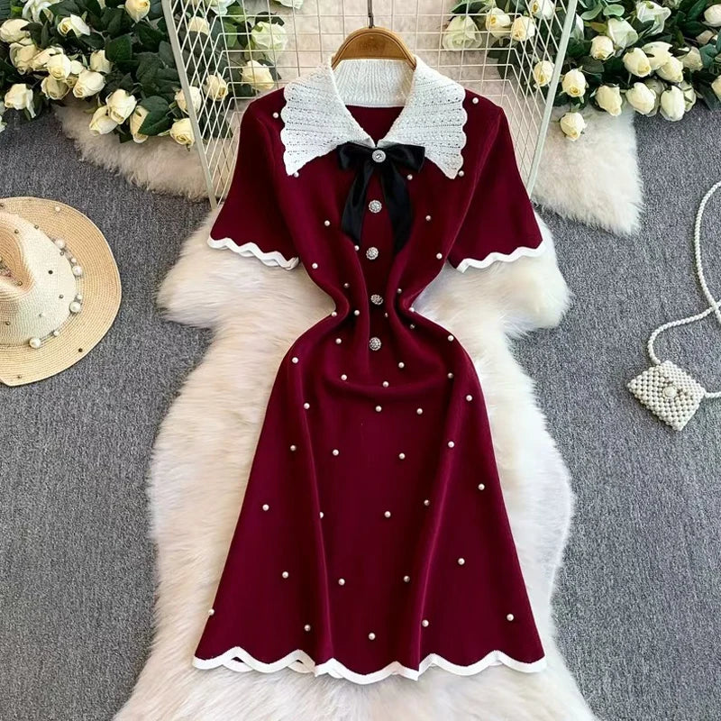 Elegant 2026 summer women's pearl dress by Showlu Smart General, featuring a bow collar, short sleeves, and a fitted bodycon style.