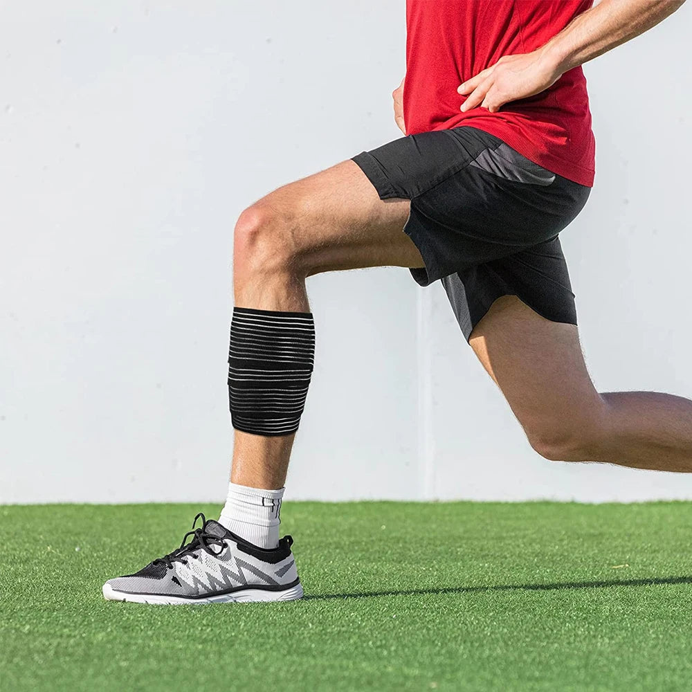 A person wearing a black and white striped elastic compression wrap on their lower leg.
