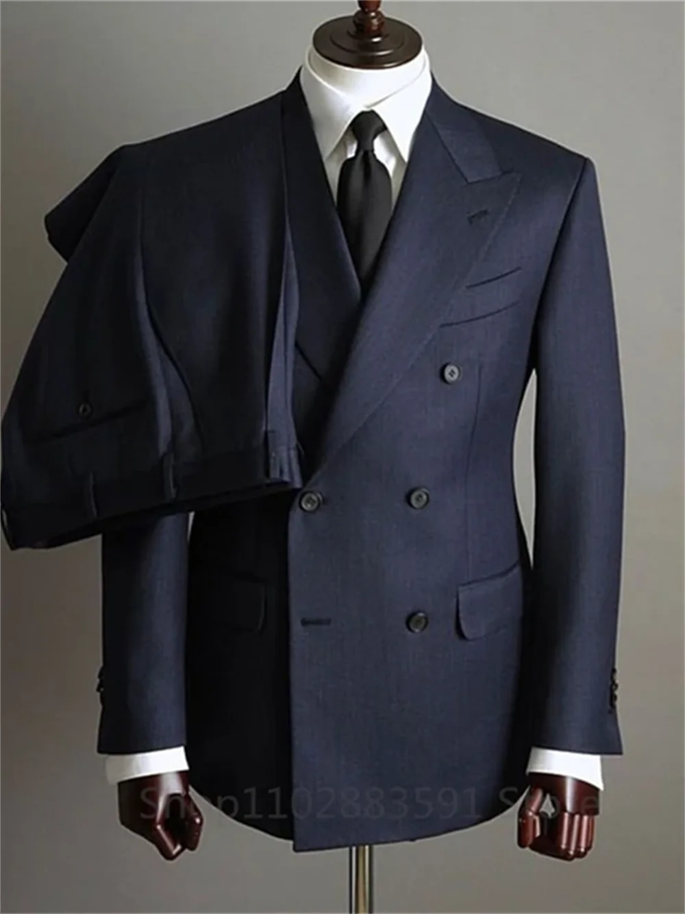 Two-piece men's tuxedo blazer and pants set with double-breasted buttons and peaked lapels, suitable for formal events and weddings.