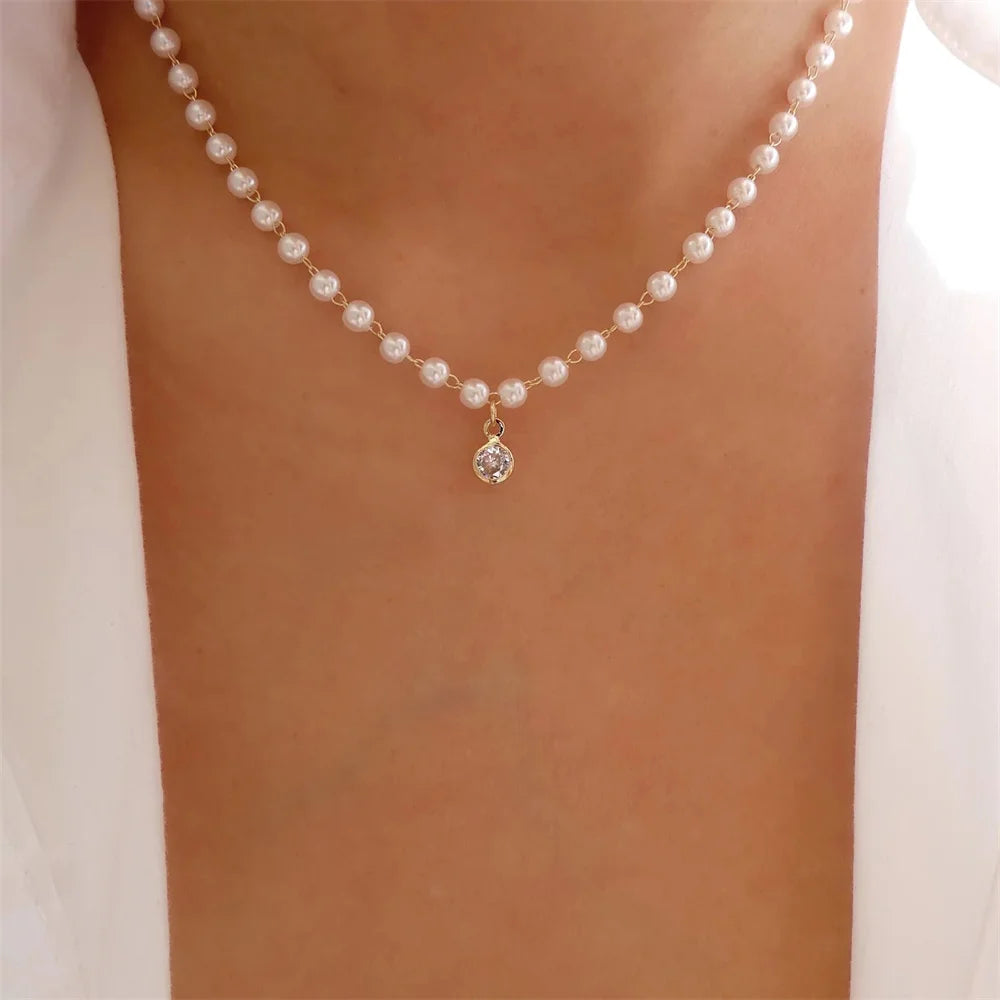 Elegant vintage pearl pendant necklace for women, featuring multi-layer gold chain choker with round pearl accents and trendy jewelry design.