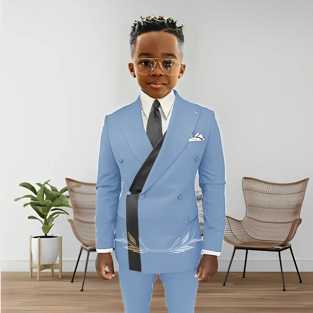 Young boy wearing Showlu Fashion boys' double-breasted blazer and pants tuxedo set for wedding or formal occasions.