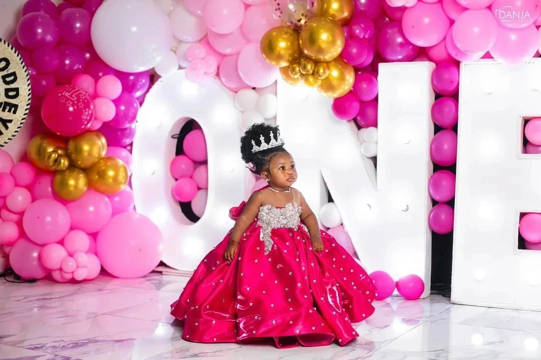 Pink satin flower girl dress for kids with puffy skirt and floor length, ideal for weddings, birthdays, and first communions.